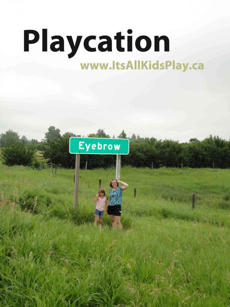 Playcations (Staycations) for families - picture in front of a road sign